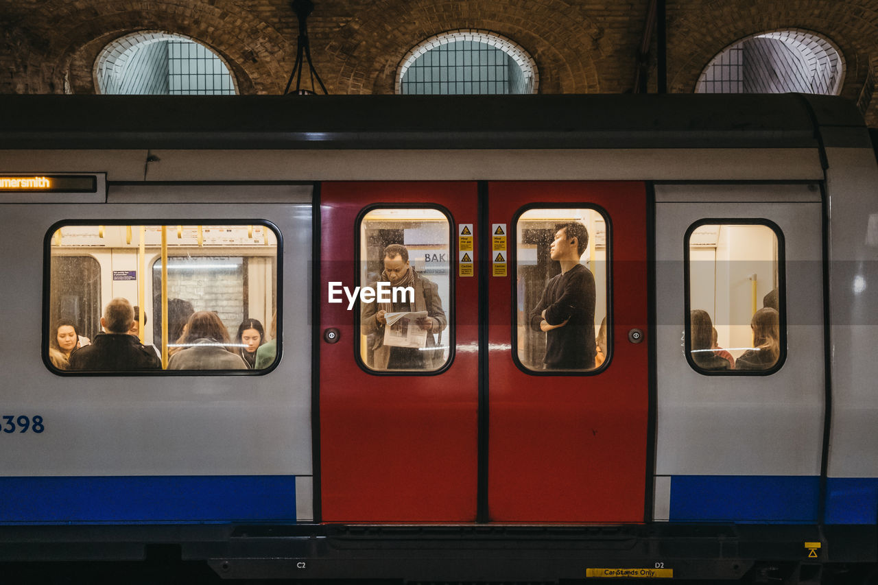 TRAIN AT RAILROAD STATION PLATFORM SEEN THROUGH WINDOW