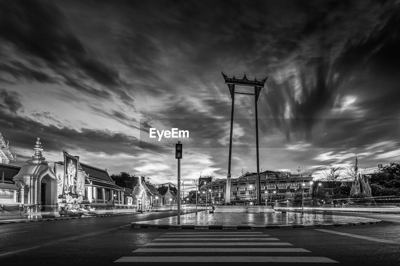 Street light by road against sky in city