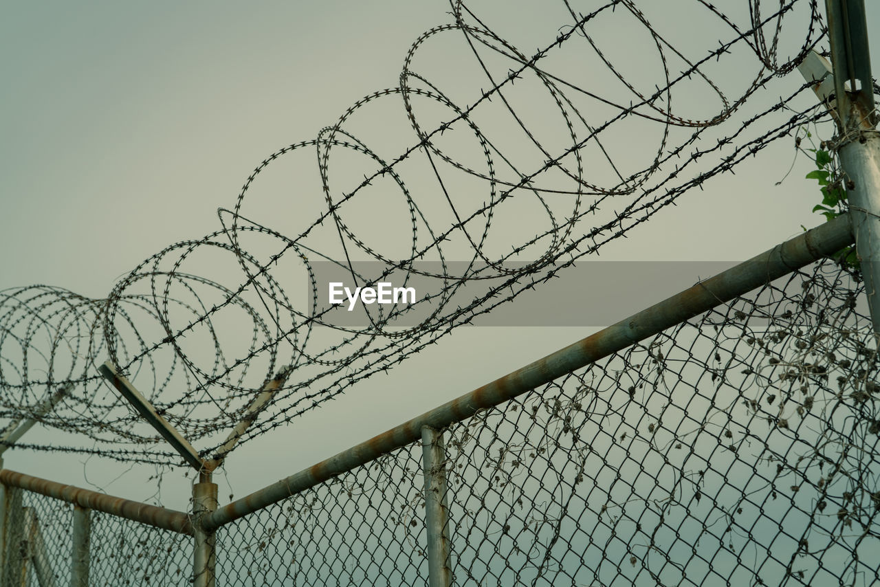 Prison security fence. barbed wire security fence. razor wire jail fence. barrier border. 