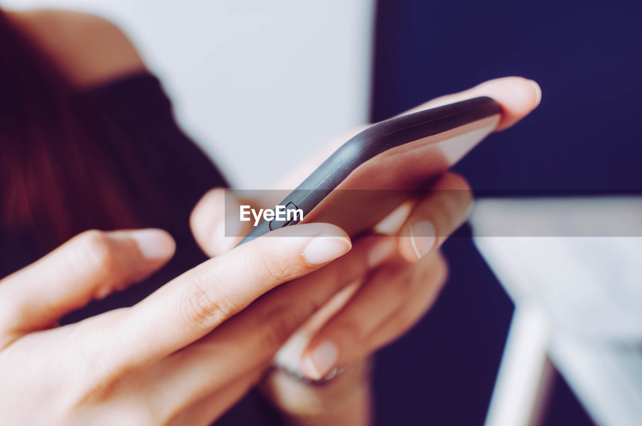 Midsection of woman using phone