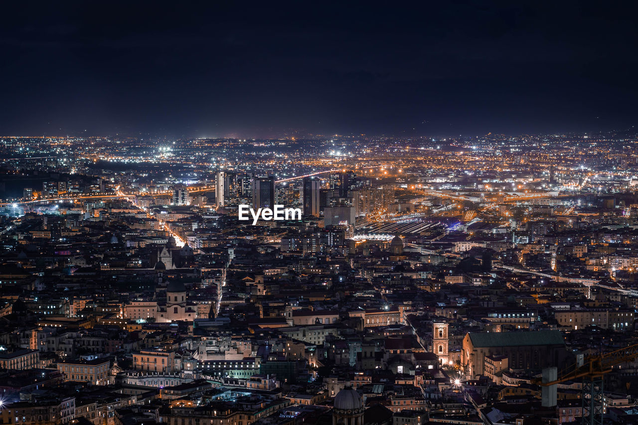 High angle view of illuminated city buildings at night