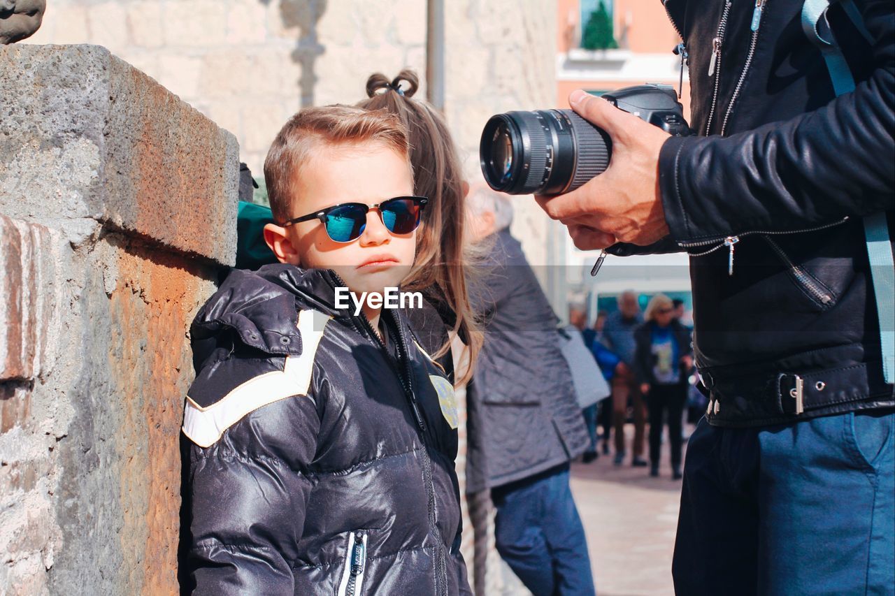 Boy wearing sunglasses standing outdoors