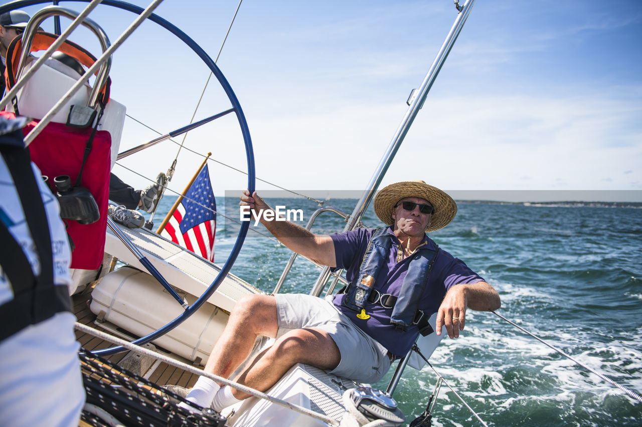 Middle aged man sailing on a sunny day