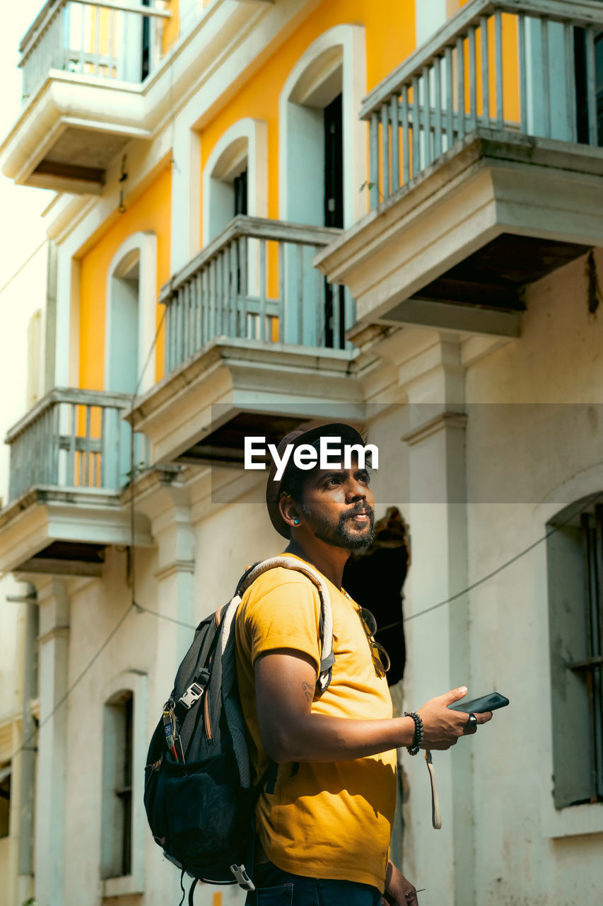 Low angle view of man using mobile phone