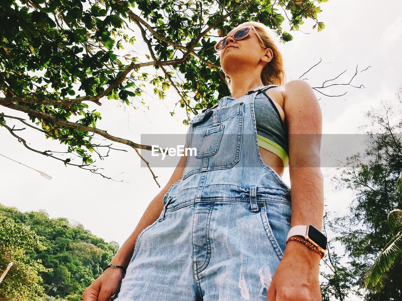 Low angle view of woman standing against sky