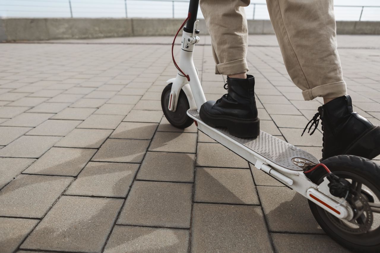 Low section of woman on push scooter