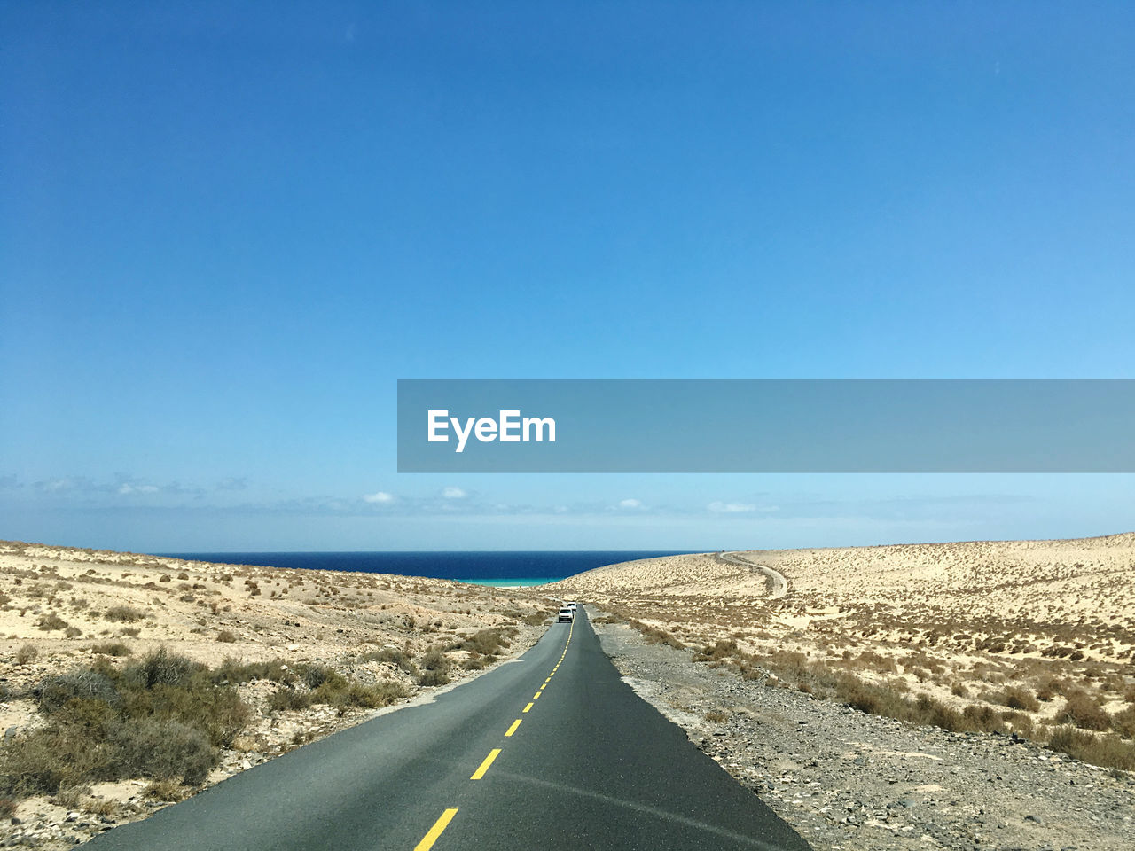 Fuerteventura road leading towards blue sky