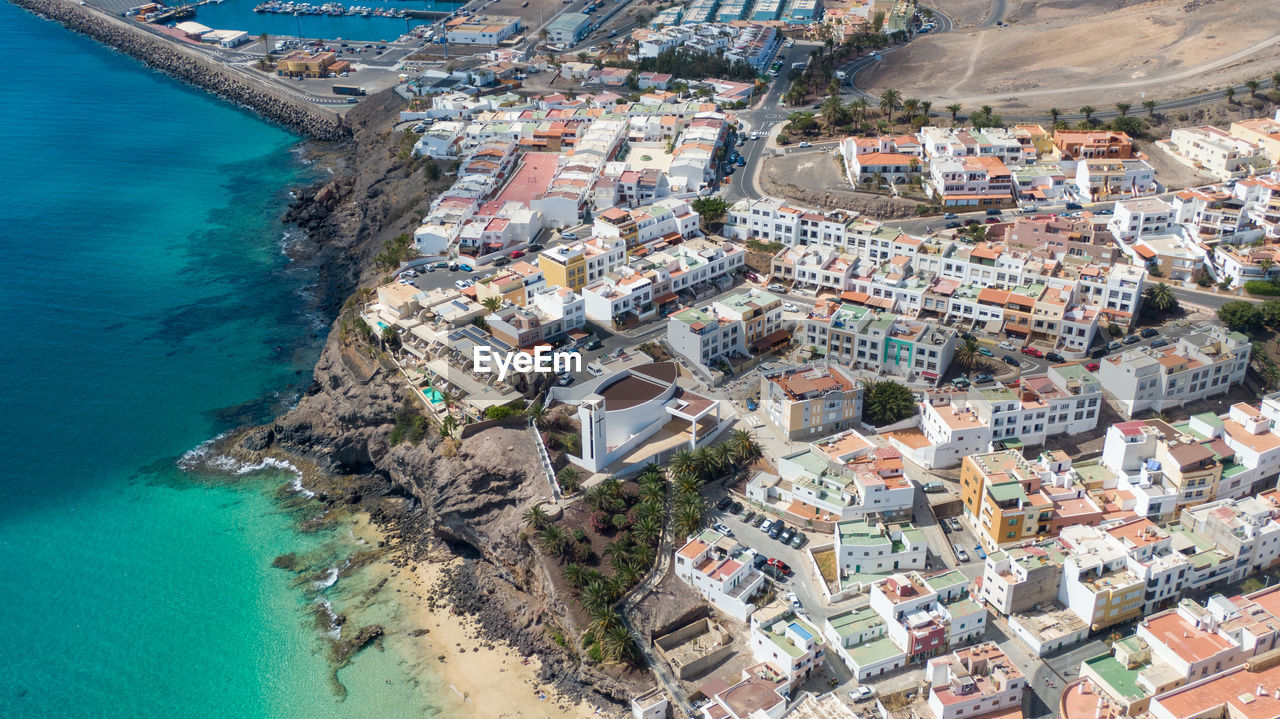 HIGH ANGLE VIEW OF CITY BUILDINGS AT SEASIDE