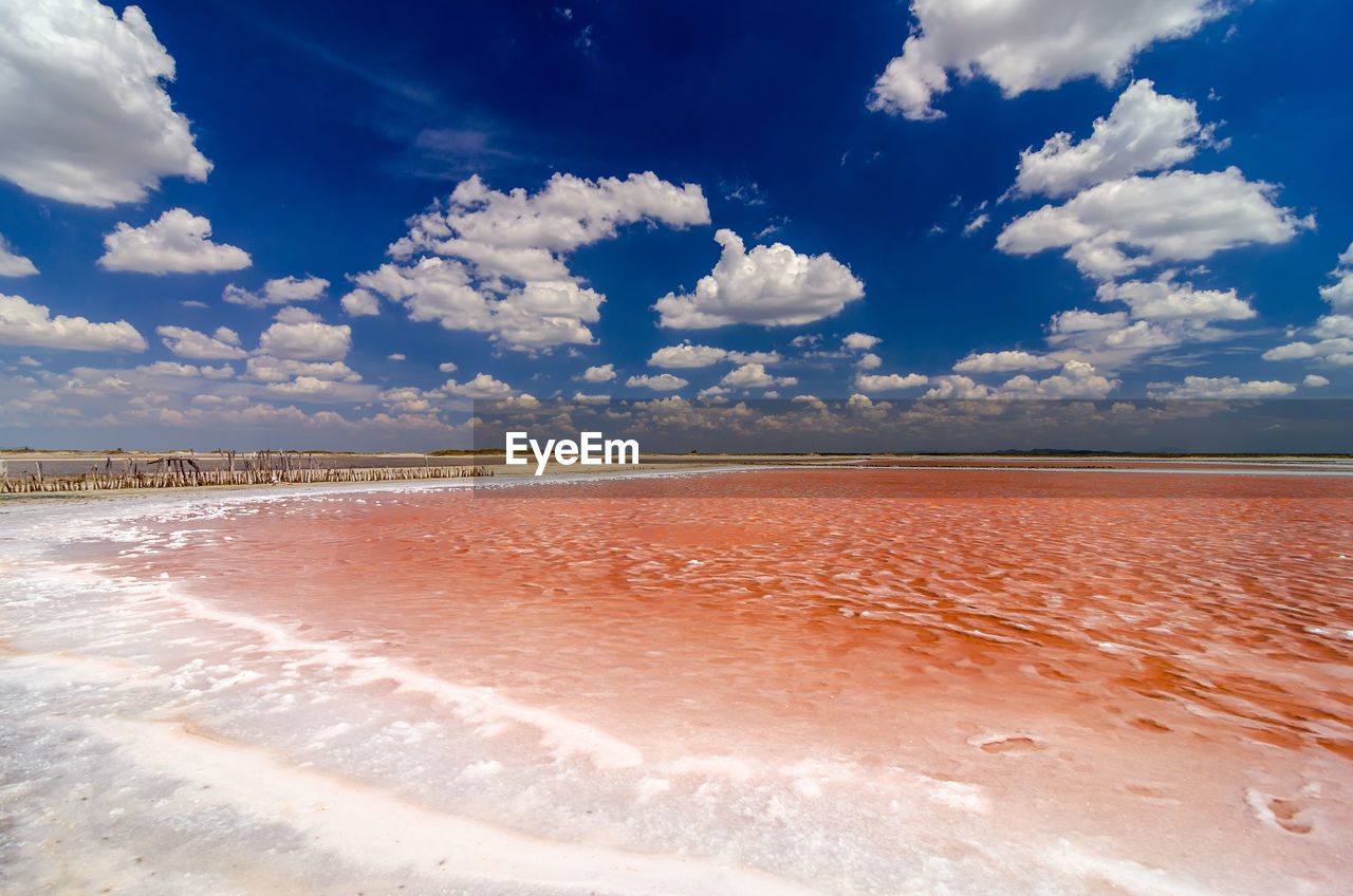 Scenic view of lagoon against cloudy sky