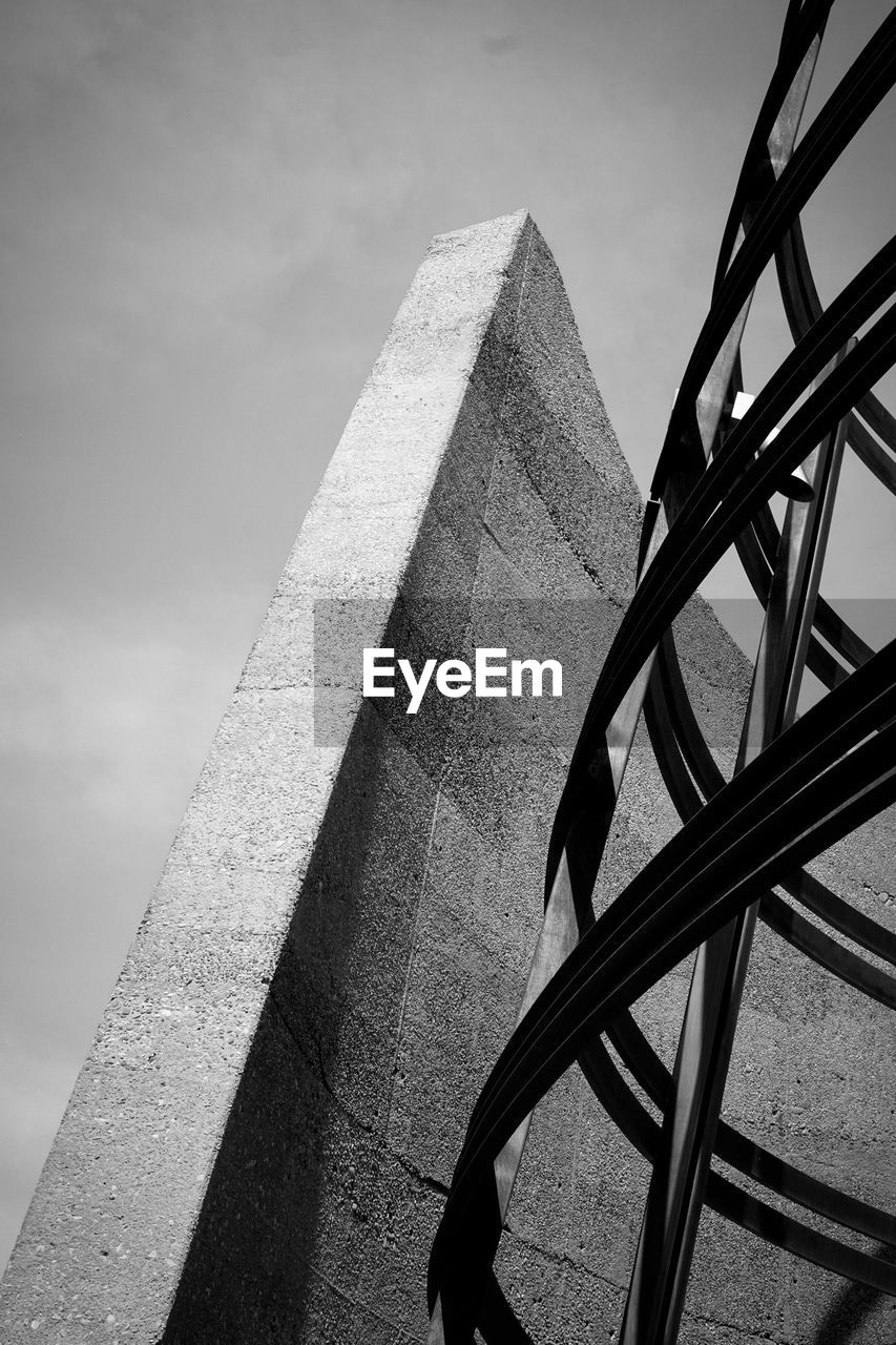 Low angle view of monument against cloudy sky