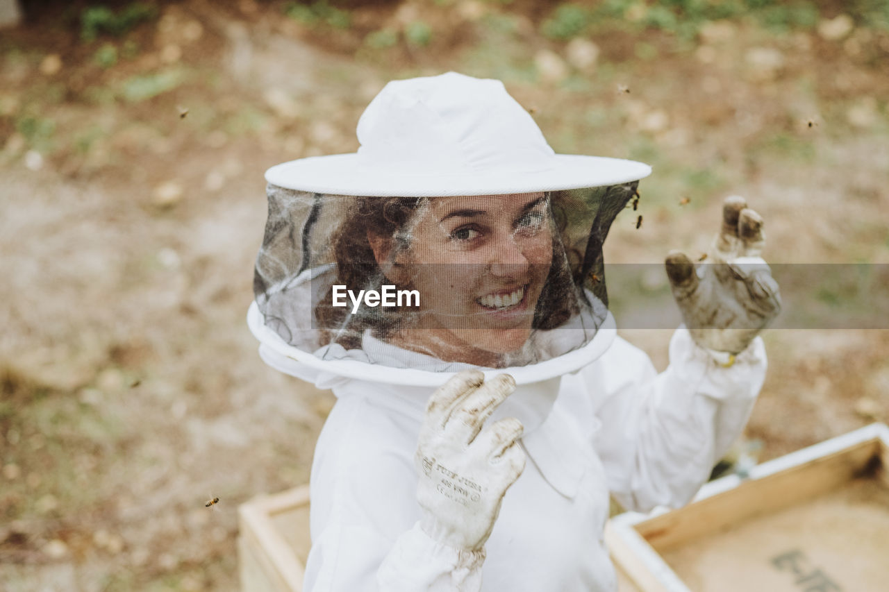 A portrait of a woman beekeeper