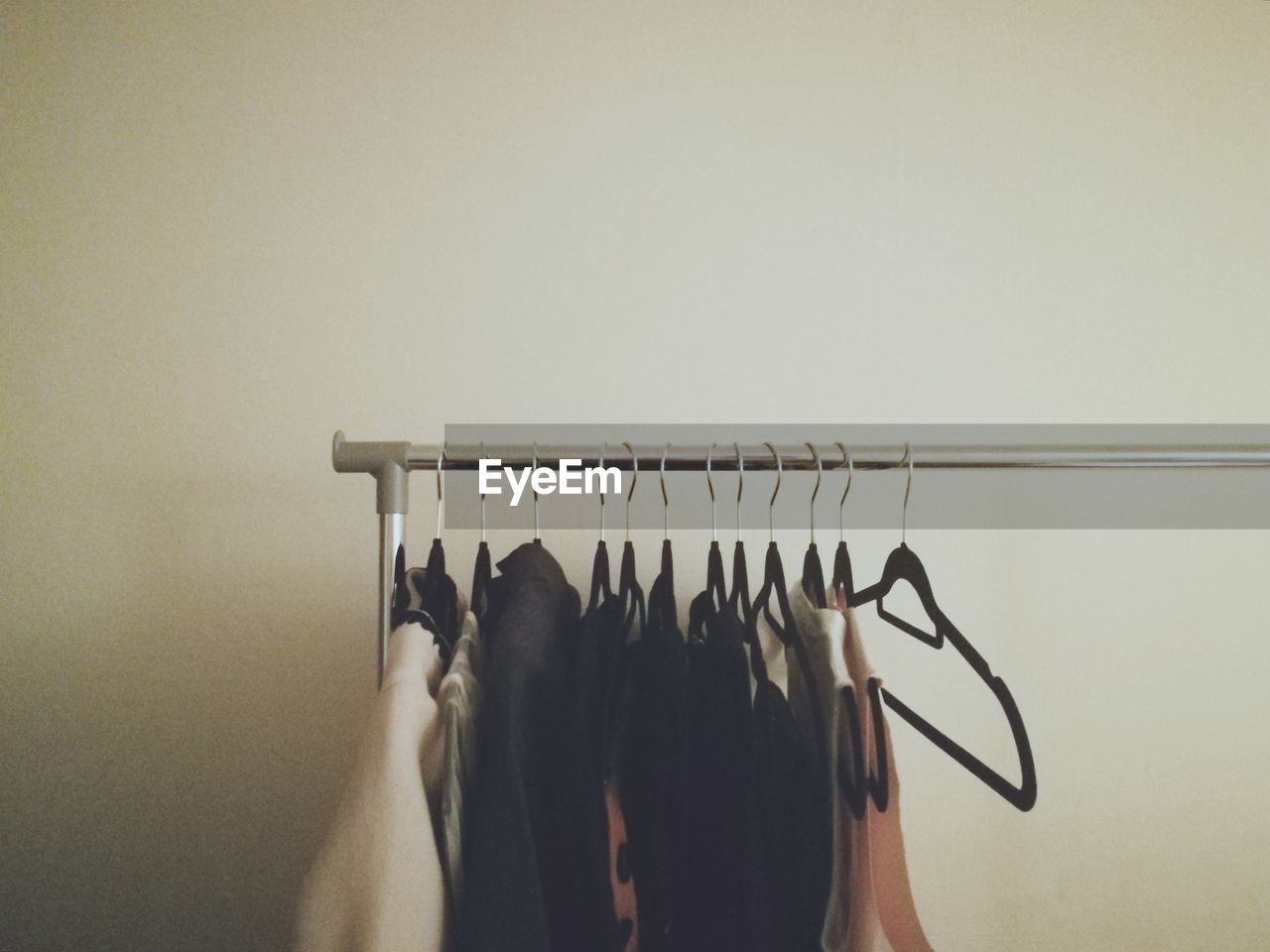 Clothes hanging on rack against wall