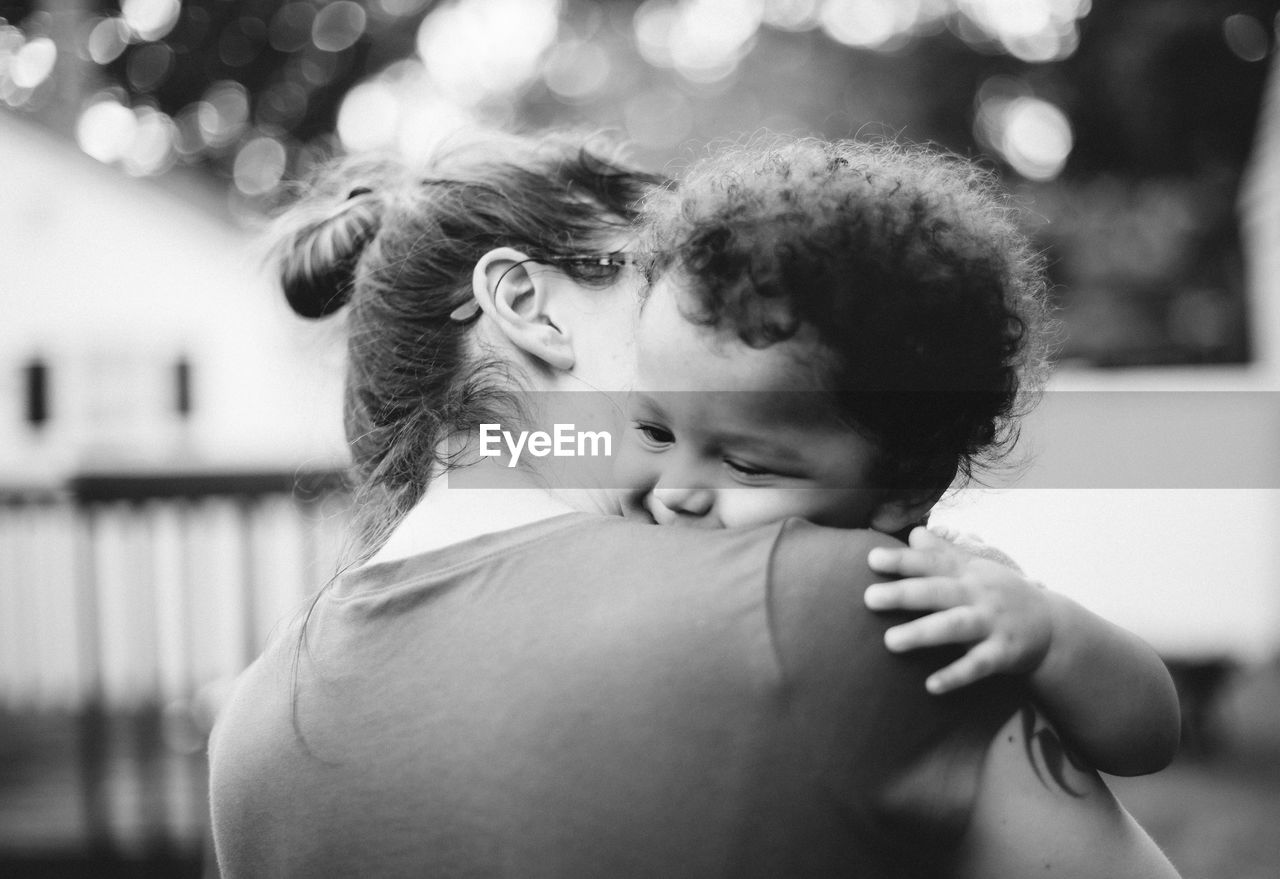 Mother embracing son outdoors