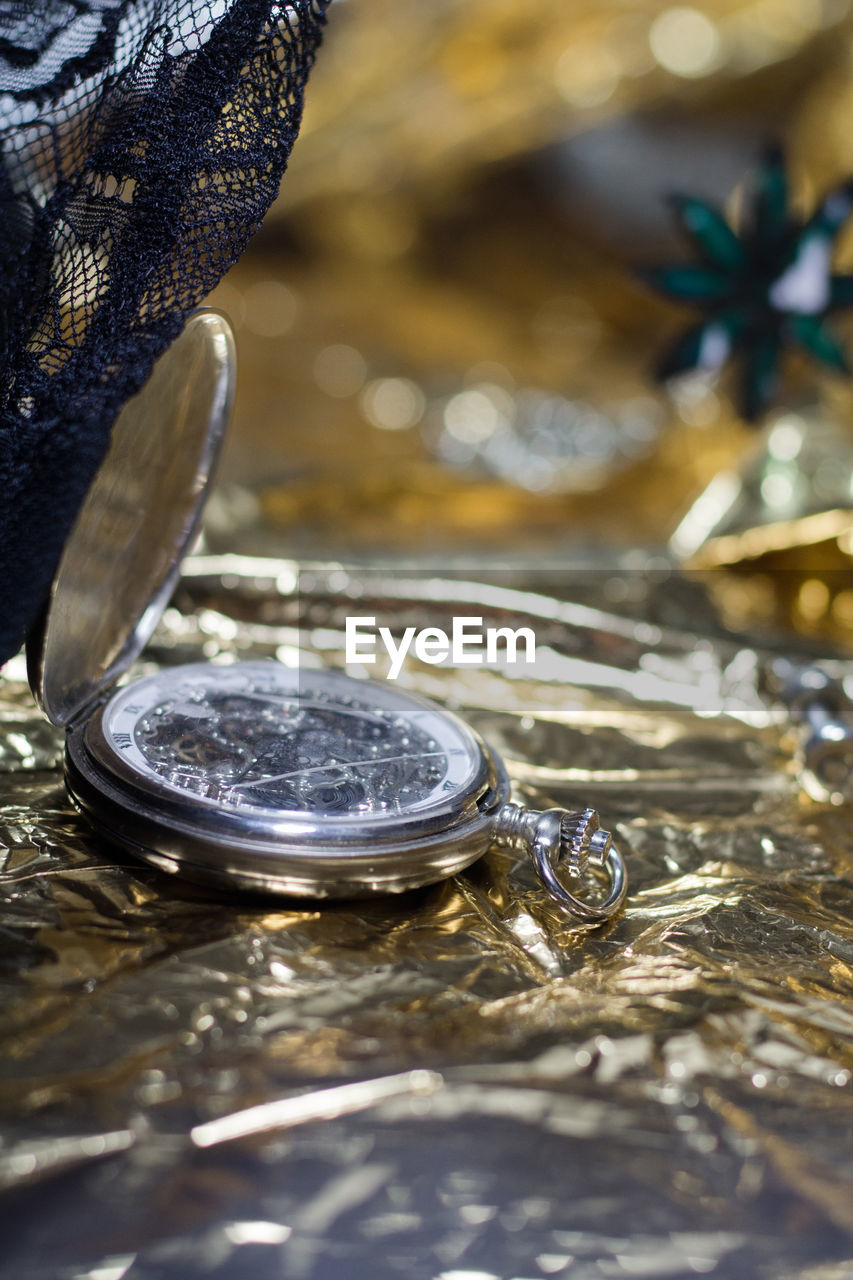 Close-up of pocket watch on table