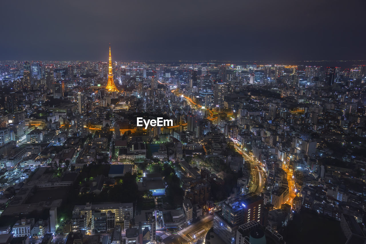 High angle view of city lit up at night