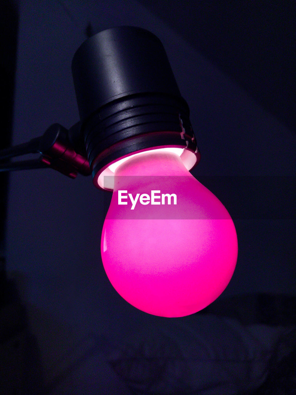 Close-up of illuminated light bulb in darkroom