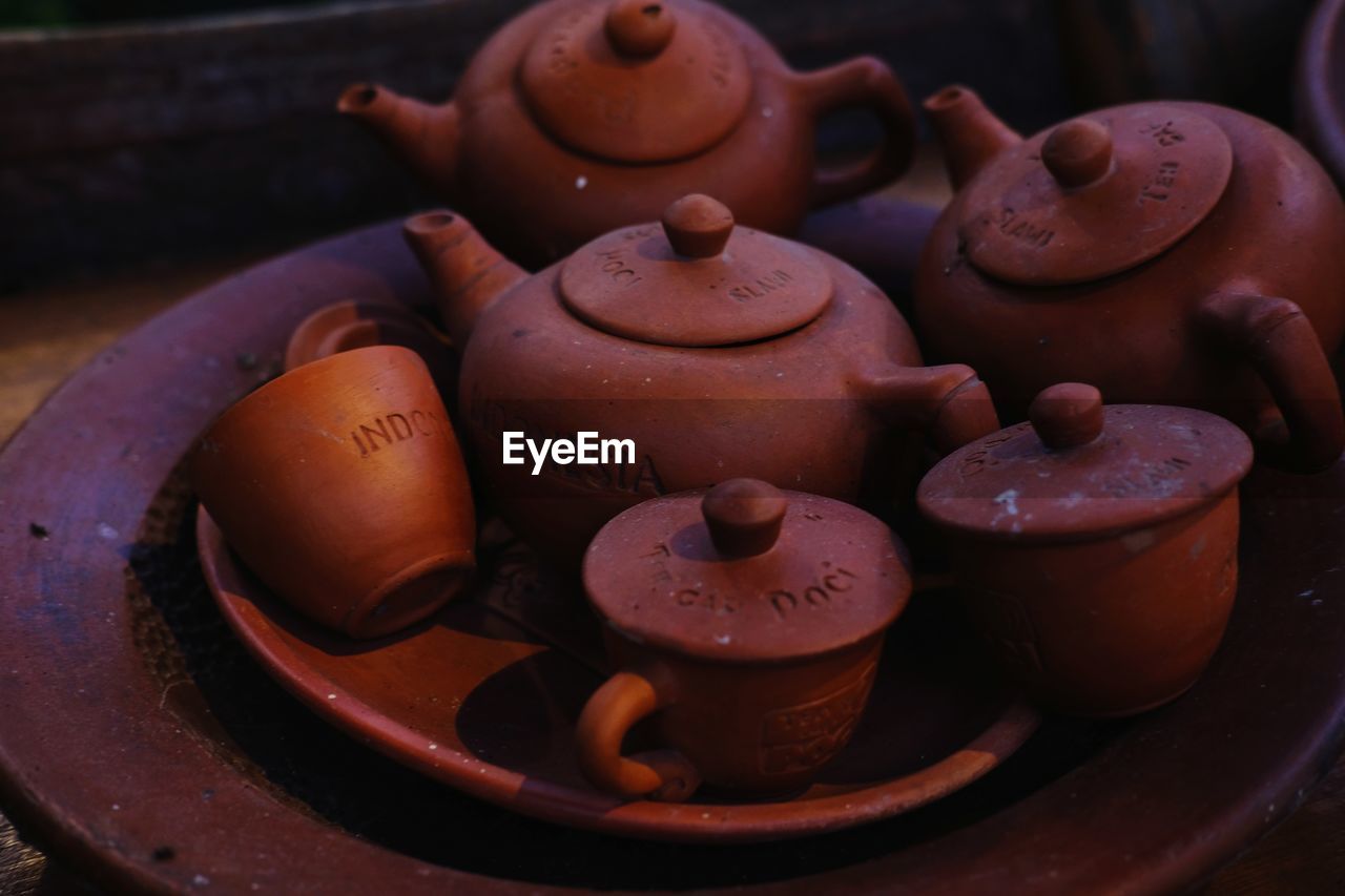 Close up of traditional clay tea pot on the table.