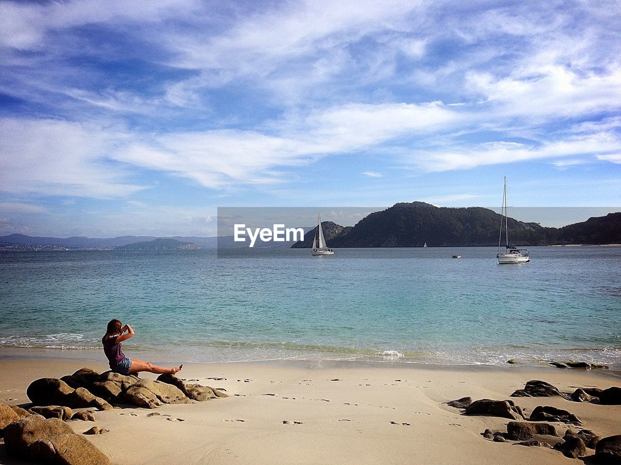 SCENIC VIEW OF SEA WITH MOUNTAIN IN BACKGROUND