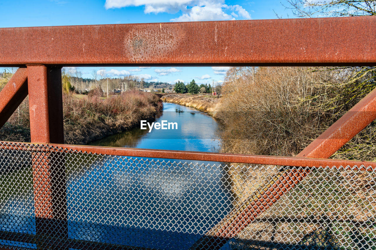 water, nature, sky, day, reflection, no people, plant, cloud, fence, architecture, tree, outdoors, metal, built structure, bridge, blue, railing, transportation, sunlight, river
