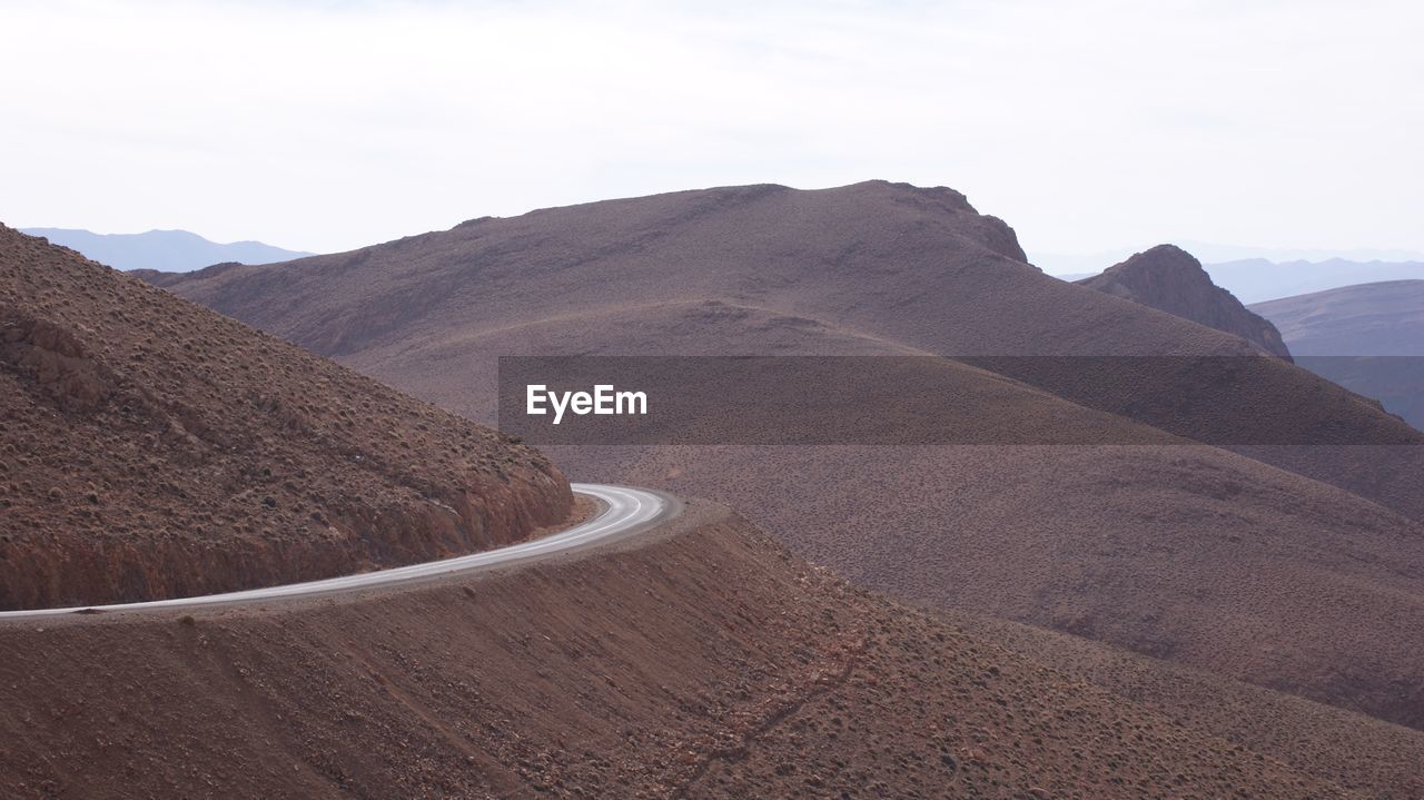 Scenic view of mountain road against clear sky