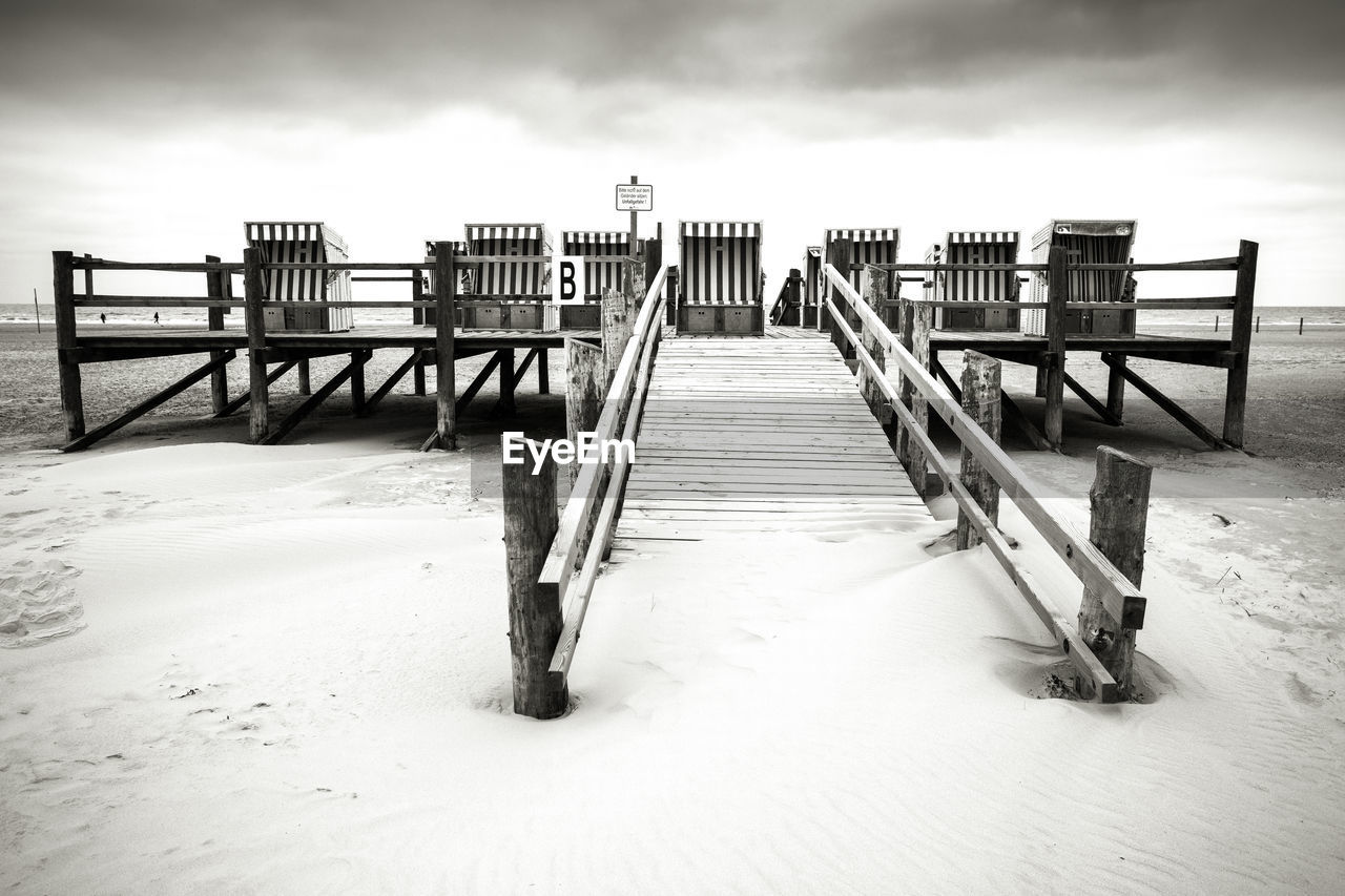 WOODEN RAILING ON BEACH DURING WINTER