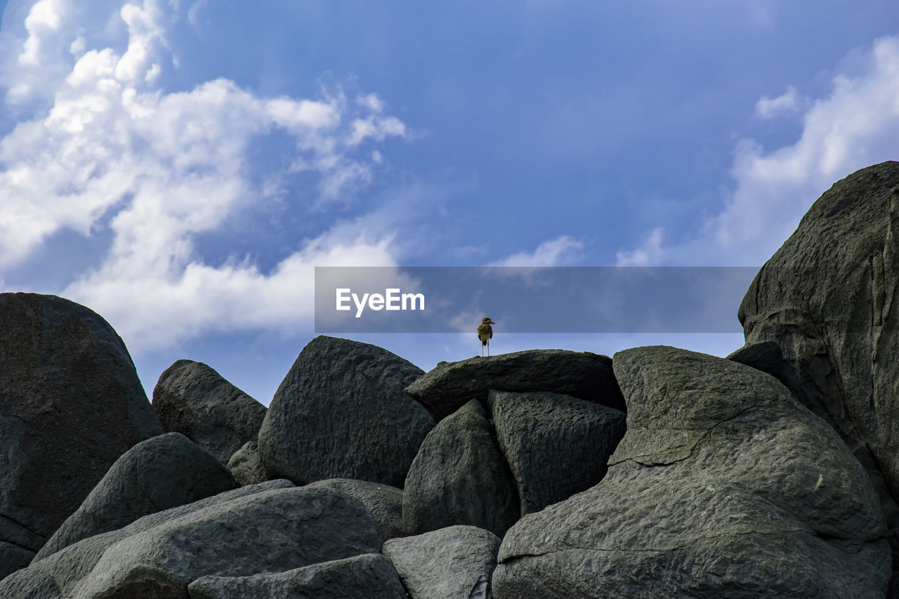 Low angle view of rock formations against sky