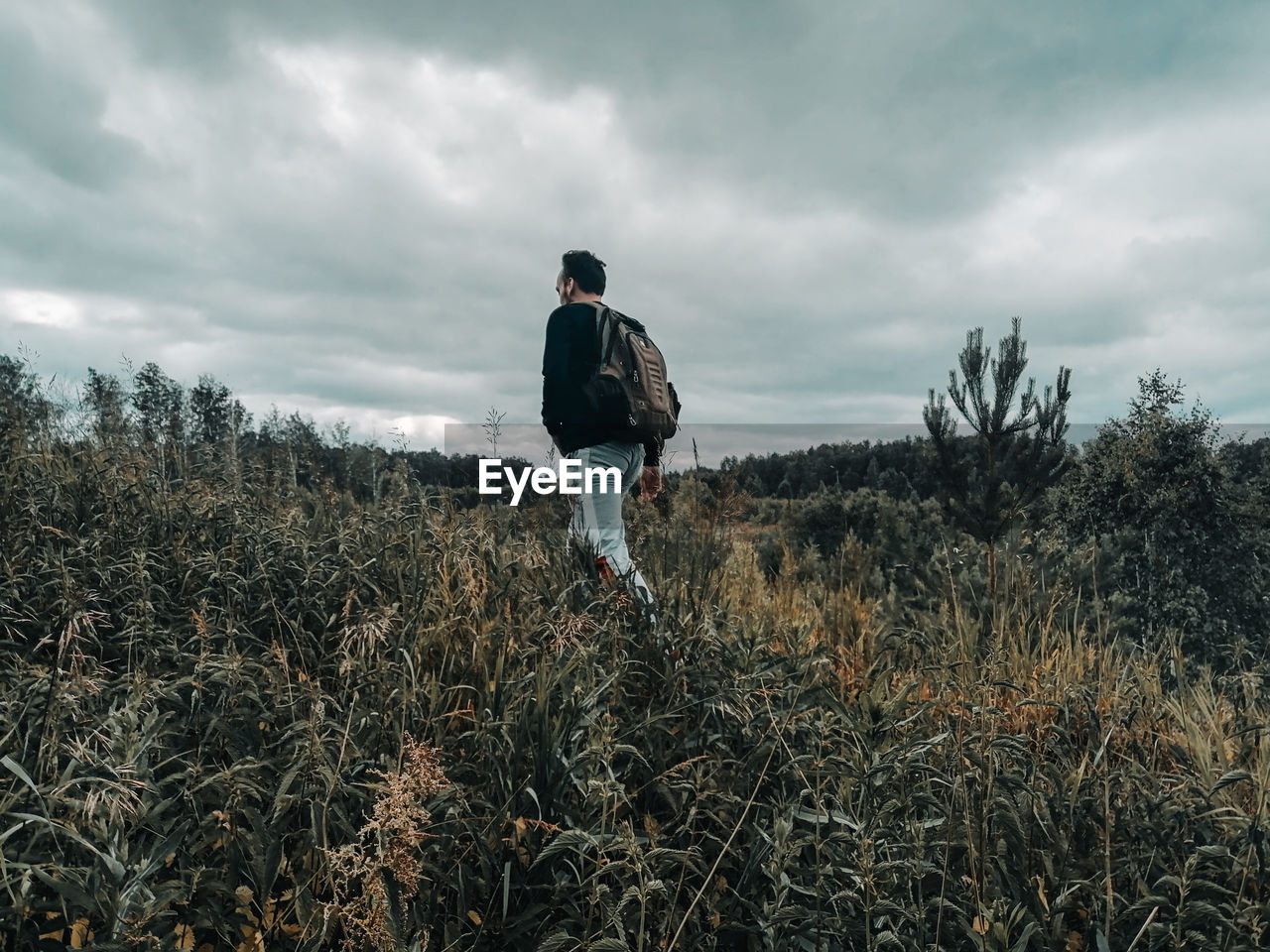 Man standing on field against sky