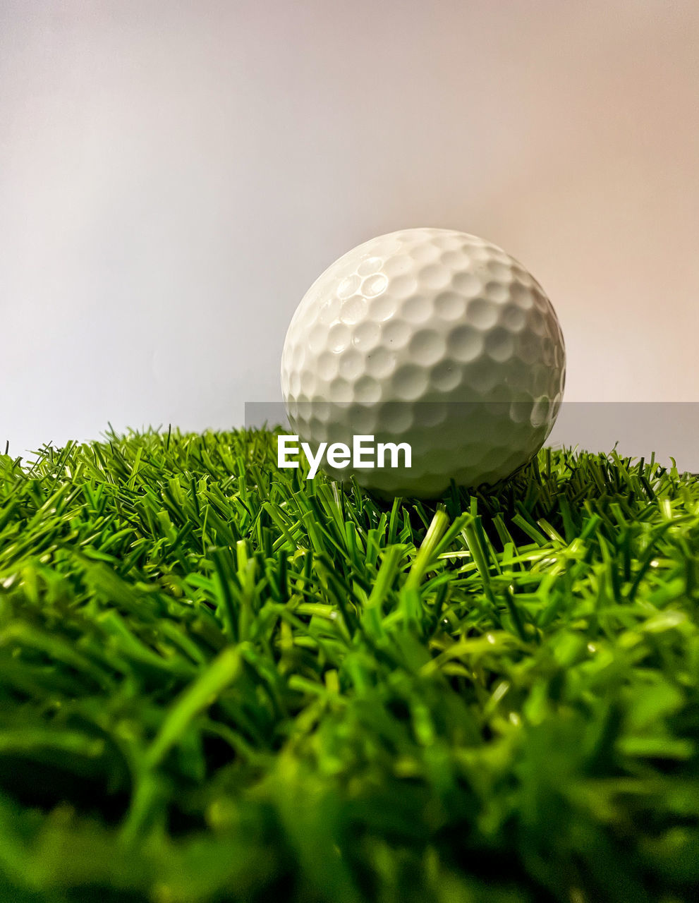 golf ball, sports, golf, activity, grass, leisure activity, golf course, green, ball, green - golf course, plant, sports equipment, close-up, golf equipment, recreation, selective focus, miniature golf, no people, sky, nature, individual sports, putting green, weekend activities, hole, competition, golf club, accuracy, copy space, relaxation, putting, lawn, tree, outdoors, tee, sphere, motion