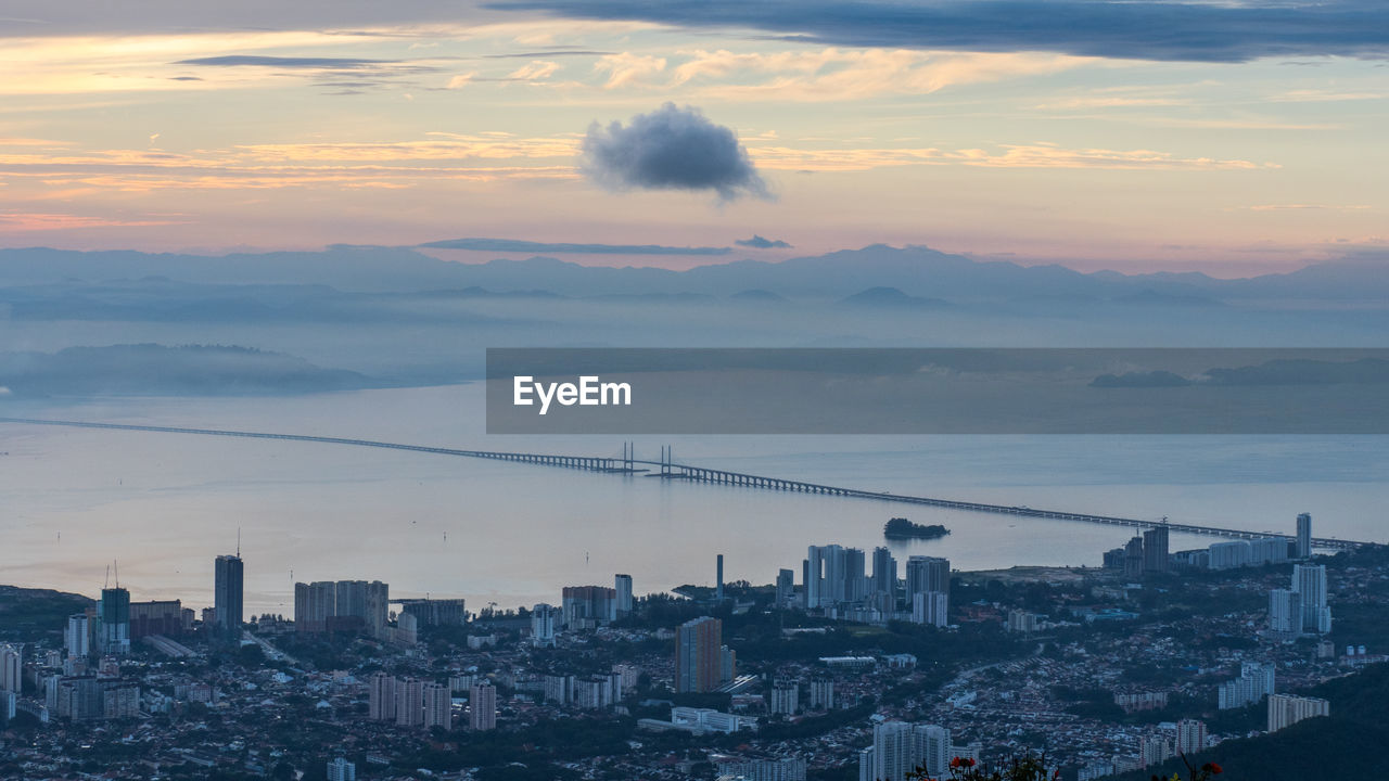 High angle view of buildings against cloudy sky