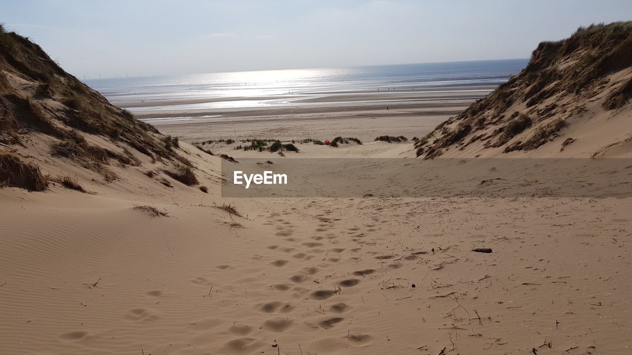 SCENIC VIEW OF SAND AGAINST CLEAR SKY