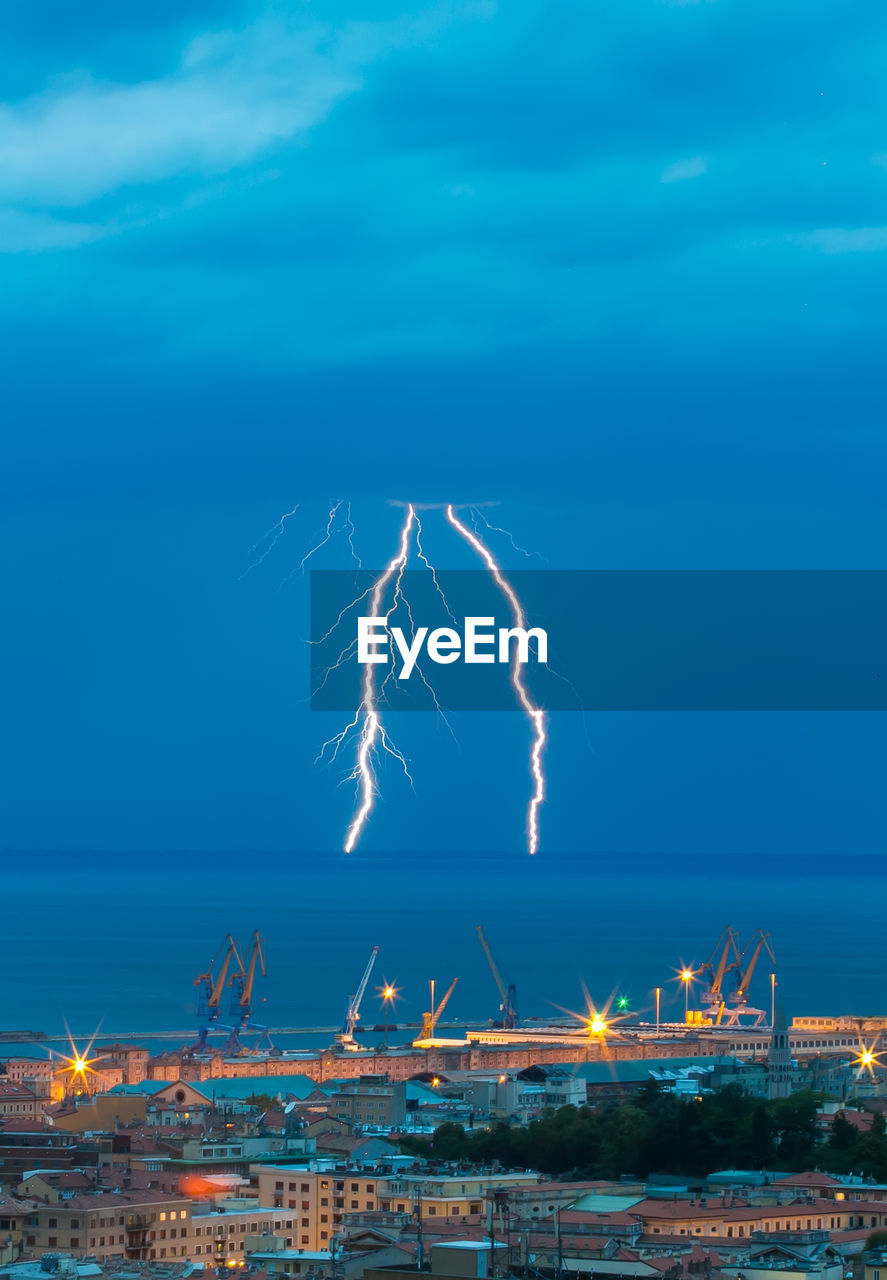 Aerial view of illuminated city against sky at night