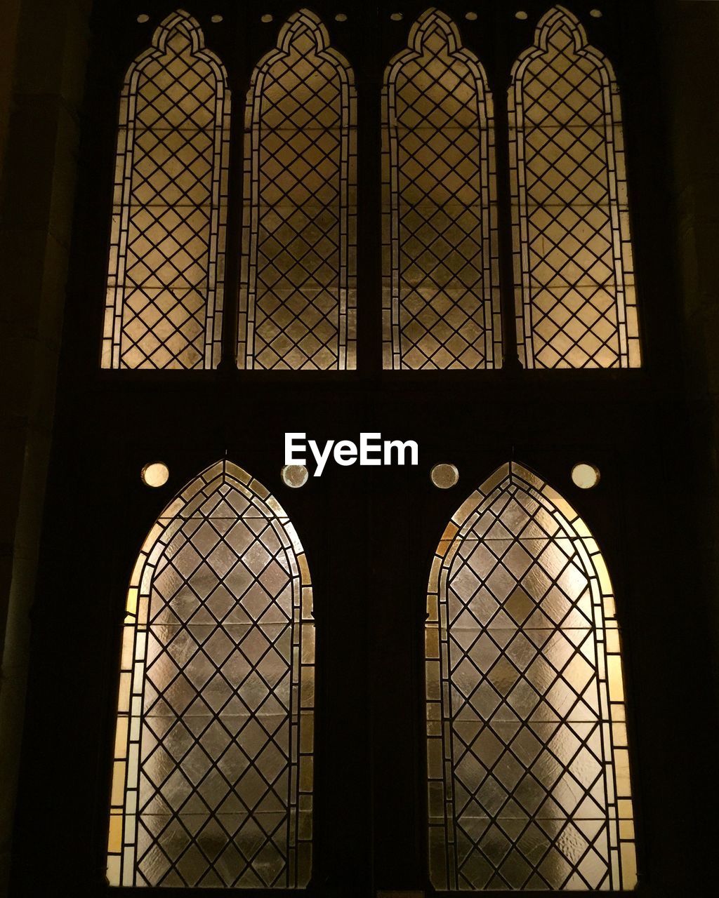 LOW ANGLE VIEW OF METAL GRATE ON WINDOW