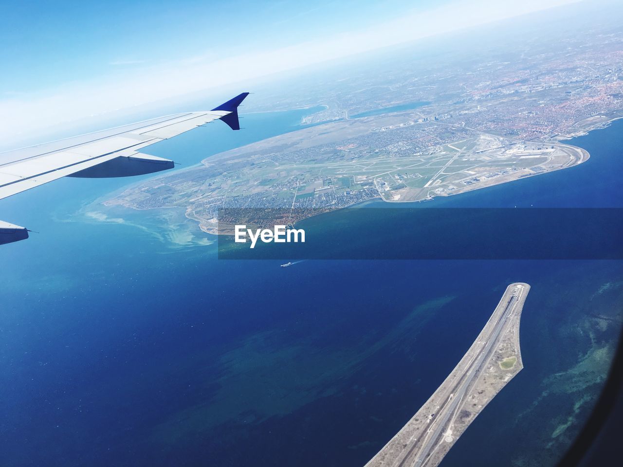 AERIAL VIEW OF AIRPLANE FLYING OVER SEA