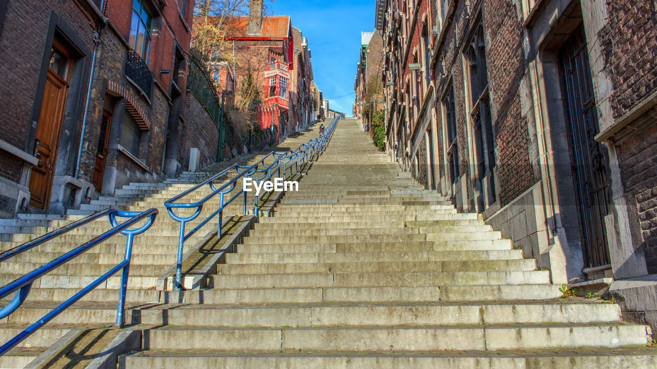 Staircase amidst buildings against sky