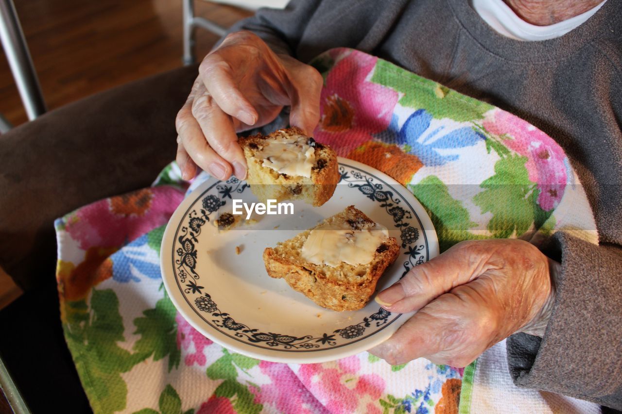 The elderly woman holding food