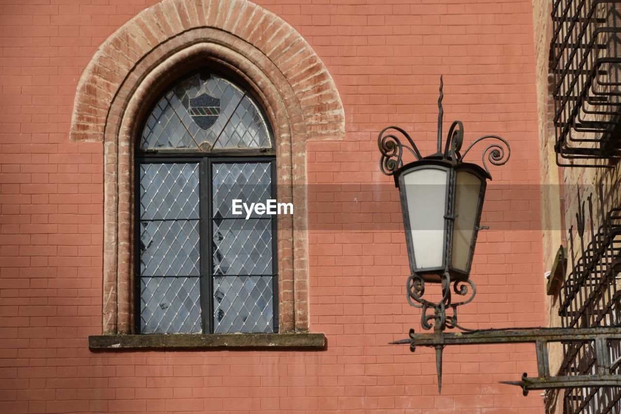 Low angle view of window and lamp