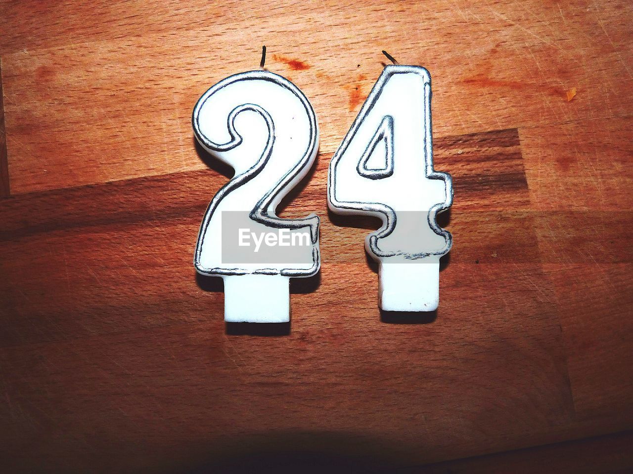 Directly above view of white birthday candles on wood