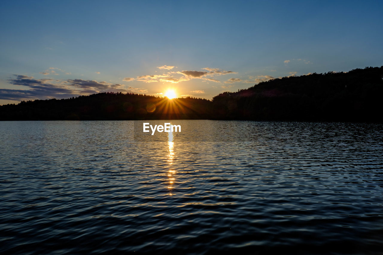 Scenic view of lake against sky during sunset