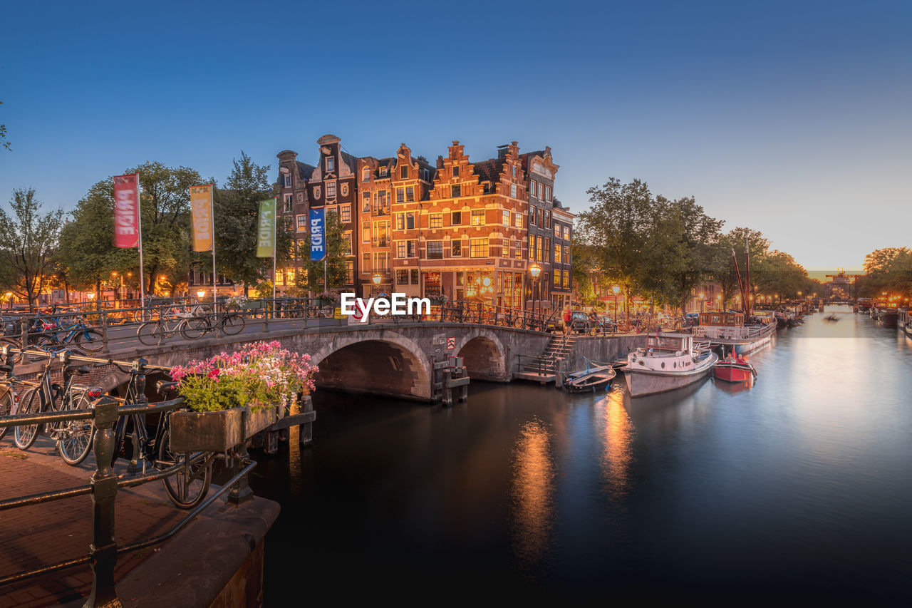 Amsterdam canals with bridge and traditional dutch houses, netherlands