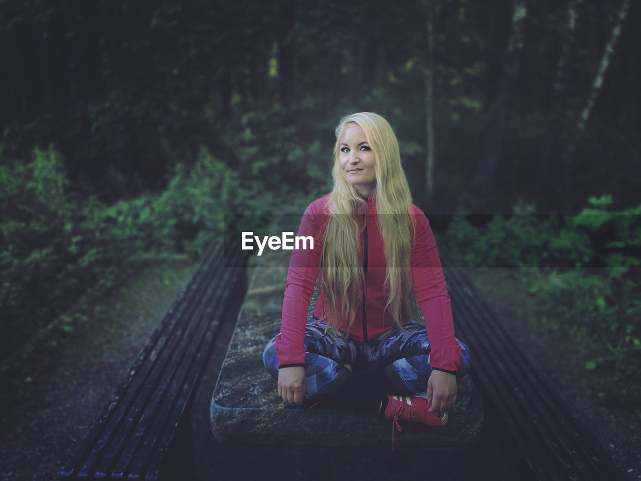 Portrait of woman sitting in forest