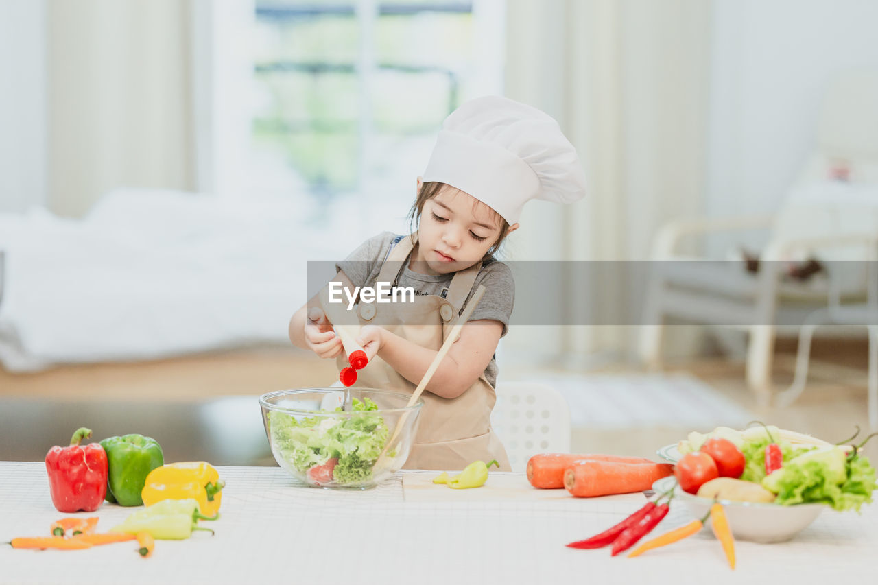 MIDSECTION OF GIRL EATING FOOD