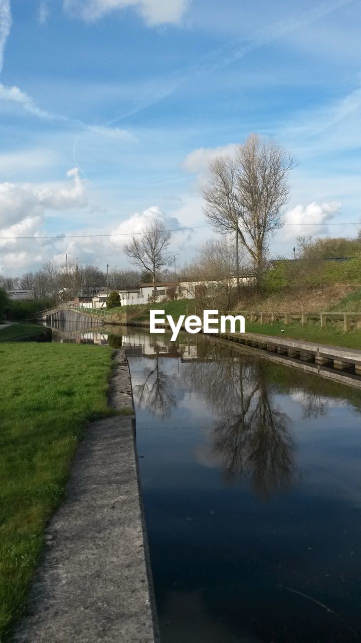 VIEW OF RIVER WITH TREES IN BACKGROUND