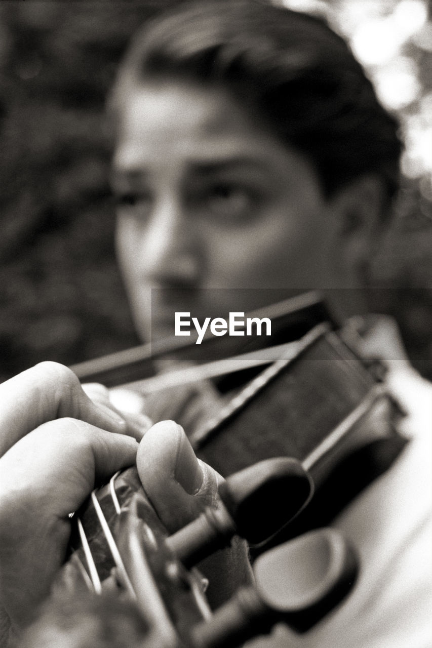 Close-up of man playing violin