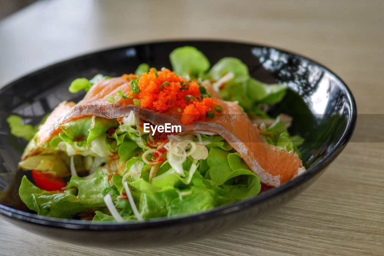 Close-up of salmon salad in bowl on table