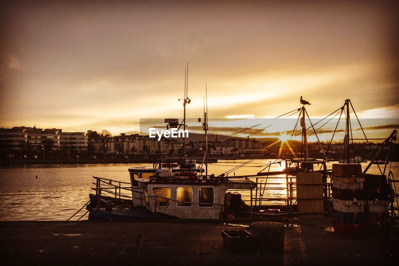 VIEW OF HARBOR AGAINST CLOUDY SKY