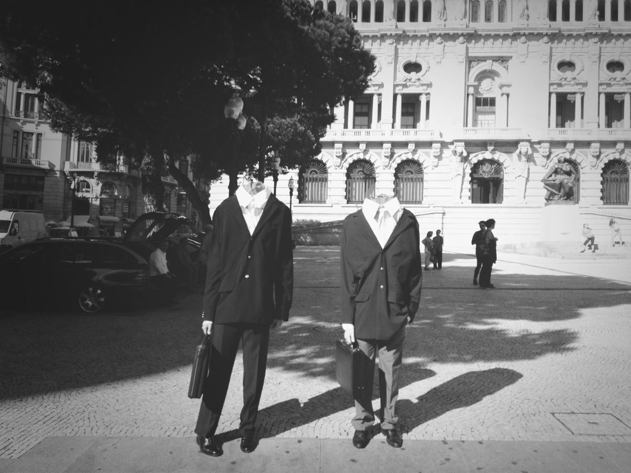 Digital composite image of businessmen standing on sidewalk with people in background