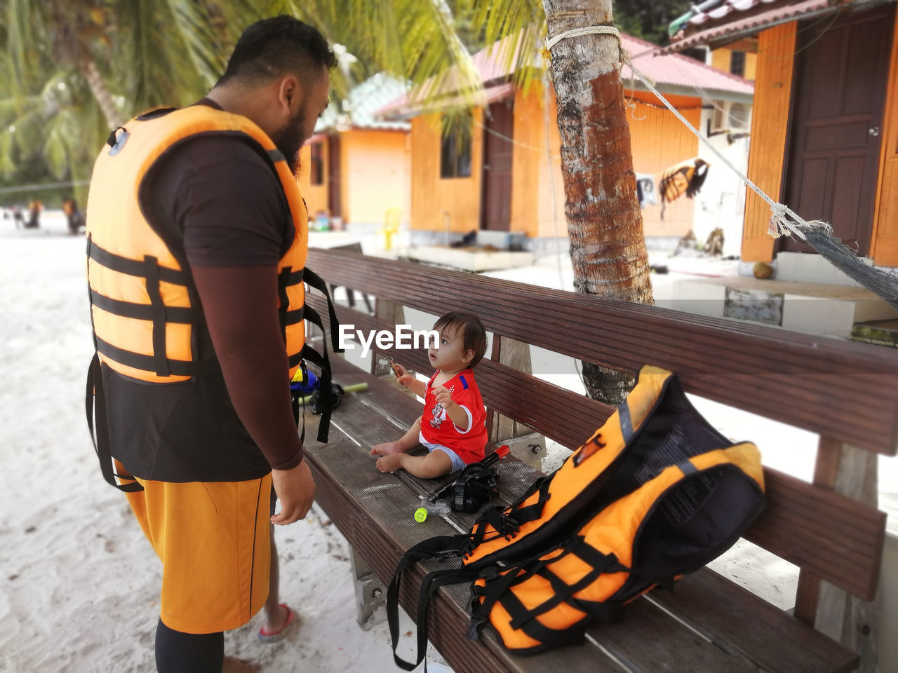 Man with baby girl at beach