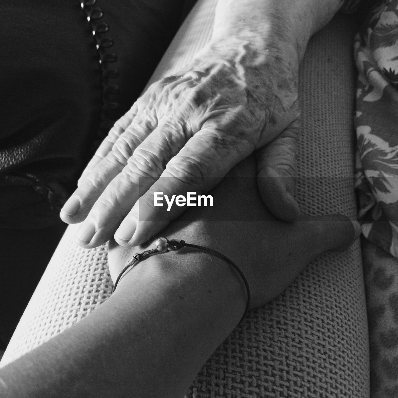 Cropped image of mother holding daughter hand