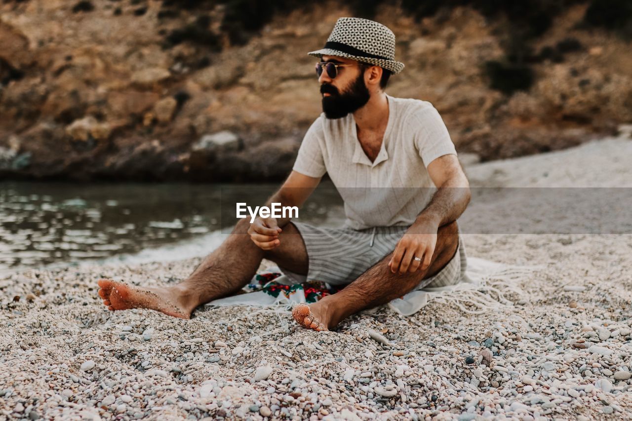 Man sitting at sea shore