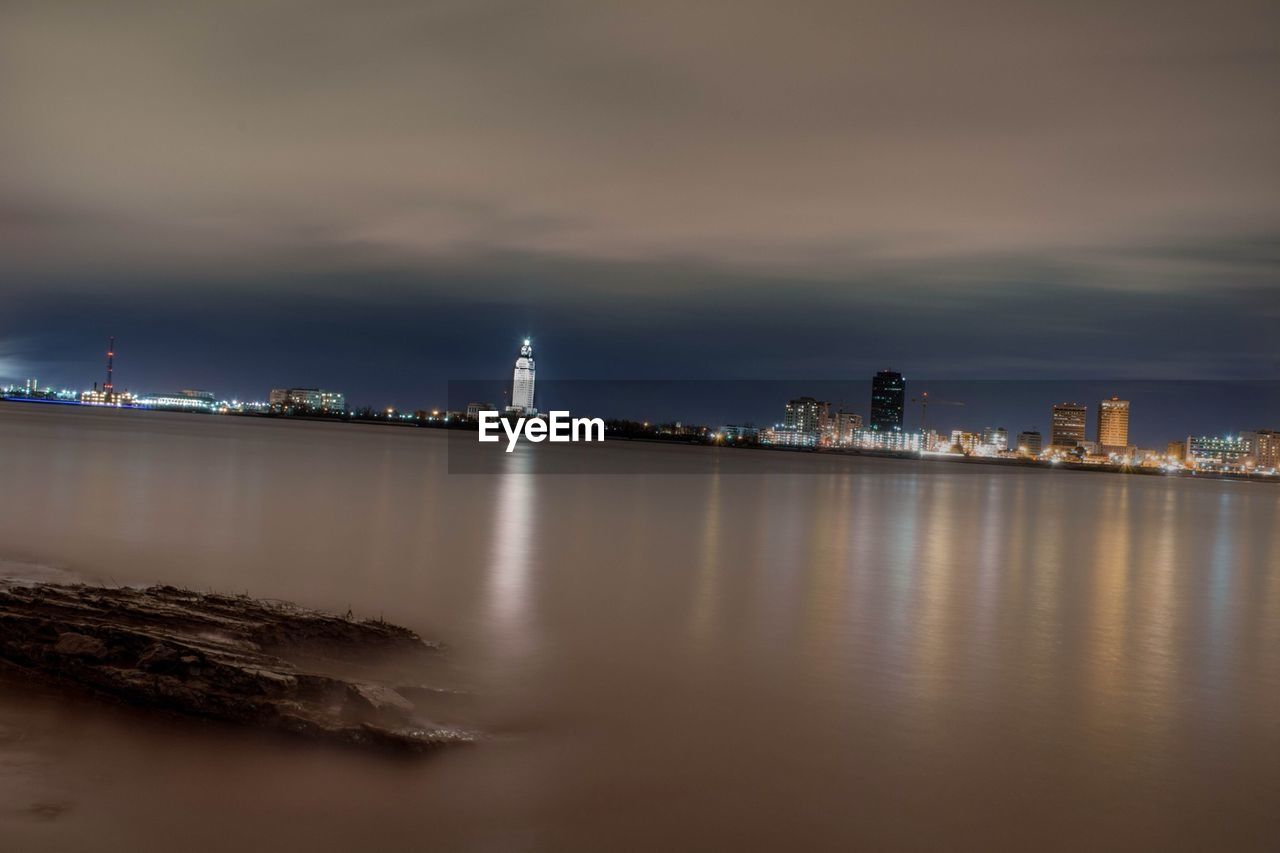 VIEW OF ILLUMINATED CITY AT NIGHT